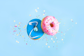 two flying sweet doughnuts - pink and blue, with sprinkles on blue