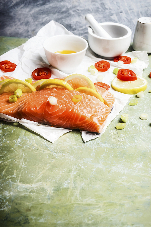 Portion piece of salmon  fish with lemon and cooking spices