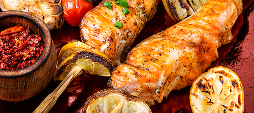 Grilled fish, grilled salmon steak with addition of lemon.Closeup