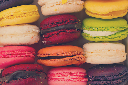 Close up pile on fresh macaroons cookies, retro toned