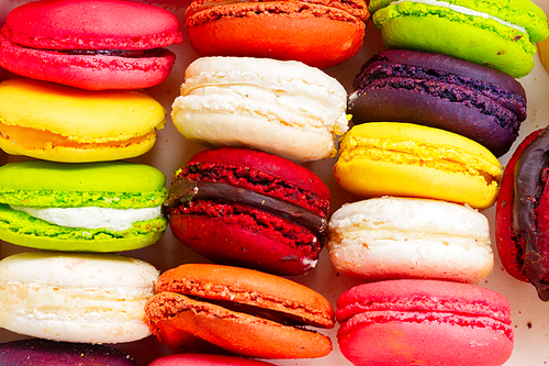 Close up pile on fresh colorful macaroons cookies