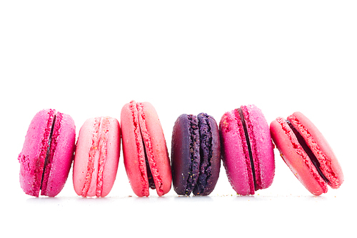 Pink macaroons cookies row isolated on white