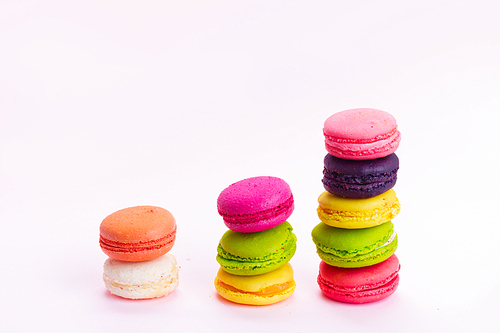 Pink macaroons cookies towers on pink background