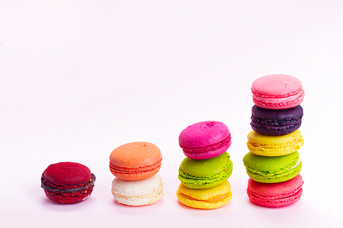 Pink macaroons cookies stacks on on pink background