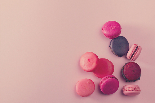 Pile of Macaroons cookies on pink background with copy space, retro toned