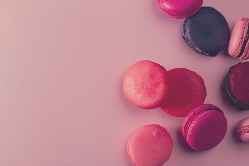 Pile of Macaroons cookies on pink background, retro toned