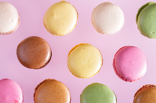 Assorted macaroons cookies pattern on pink background