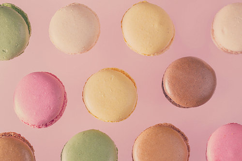 Assorted macaroons cookies pattern on pink background, retro toned