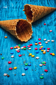 two empty waffle cone for ice cream on wooden turquoise background