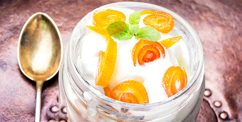 Vanilla ice cream in bowl with orange jam