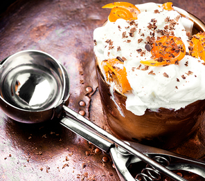 Vanilla ice cream in bowl with orange jam