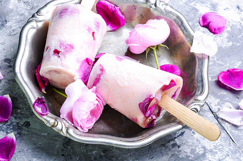 Summer vanilla ice cream with fresh rose flowers
