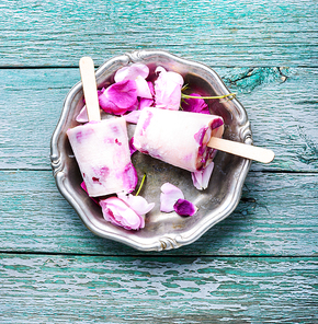 Summer vanilla ice cream with fresh rose flowers