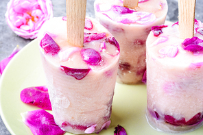 Summer vanilla ice cream with fresh rose flowers