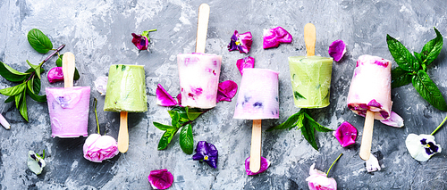 Summer vanilla ice cream with fresh flowers and mint