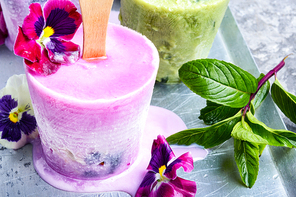 Summer vanilla ice cream with fresh flowers and mint