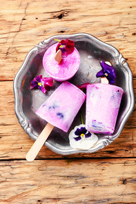 Summer vanilla ice cream with fresh flowers and mint