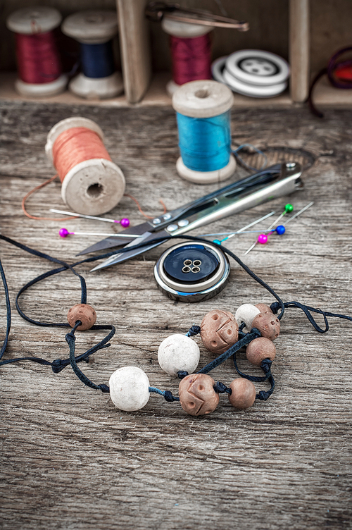 set of threads and buttons on wooden background.Selective focus