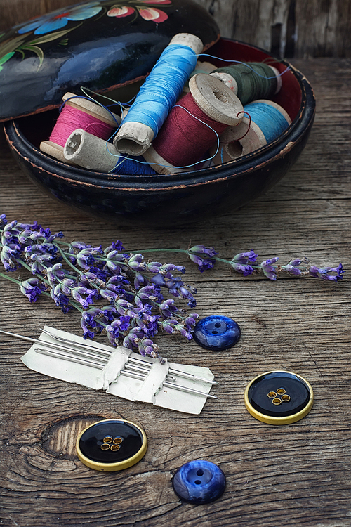 Box with reels of thread and buttons and fresh lavender