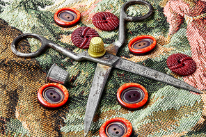Composition with tailor scissors,sewing threads and buttons from clothing