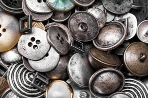 Large set of stylish old-fashioned metal buttons for clothes