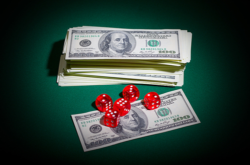 Dollars and dices on green table