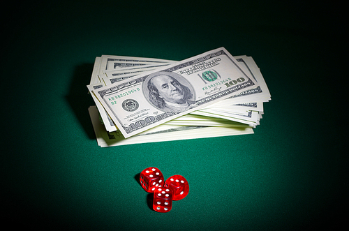 Dollars and dices on green table