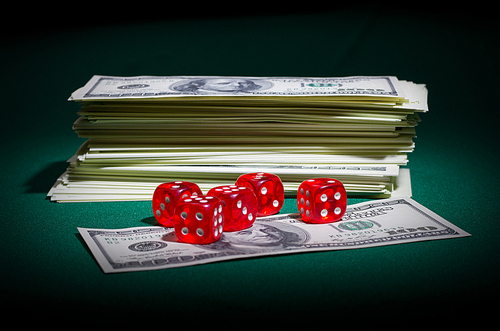 Dollars and dices on green table