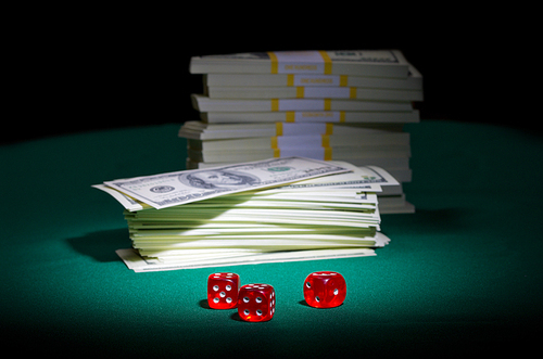 Dices and dollars on green table