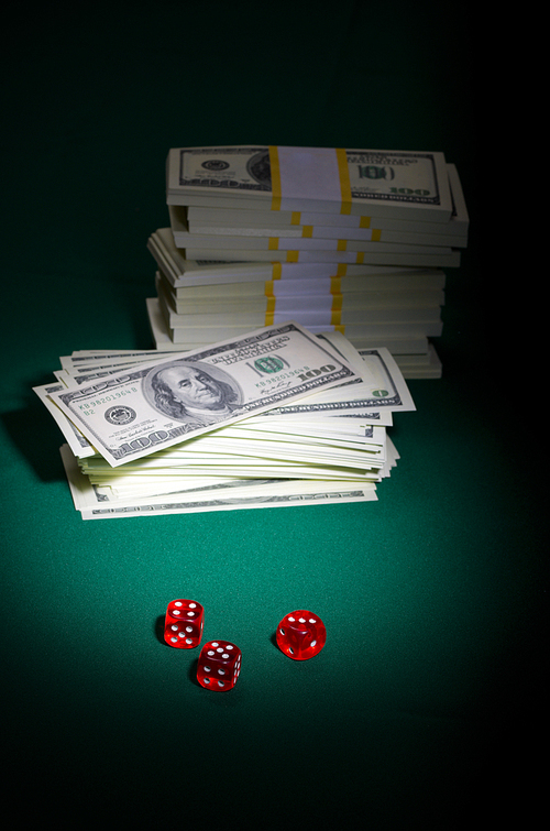 Dollars and dices on green table