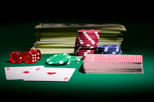 Dollars dices cards and chips on green table