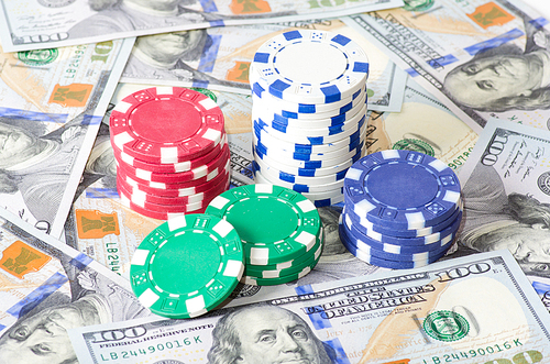 Gambling chips and heap of dollars