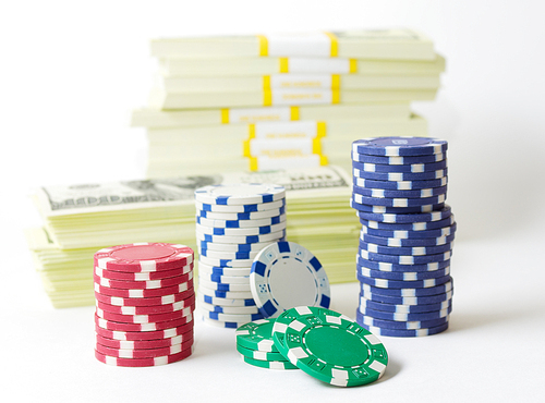 Gambling chips dices and heap of dollars isolated
