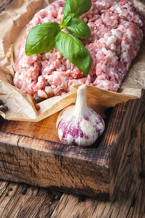 raw minced meat on vintage wooden background