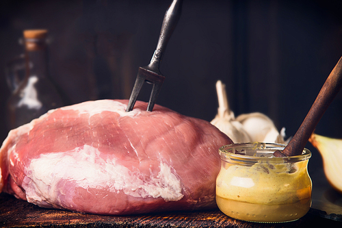 Raw ham meat with Honey Mustard Glaze in glass jar, close up