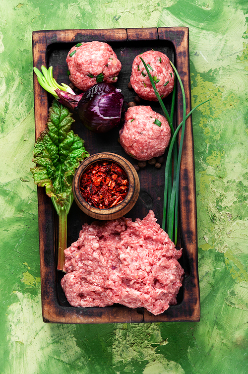Meat balls from raw beef force-meat on kitchen board