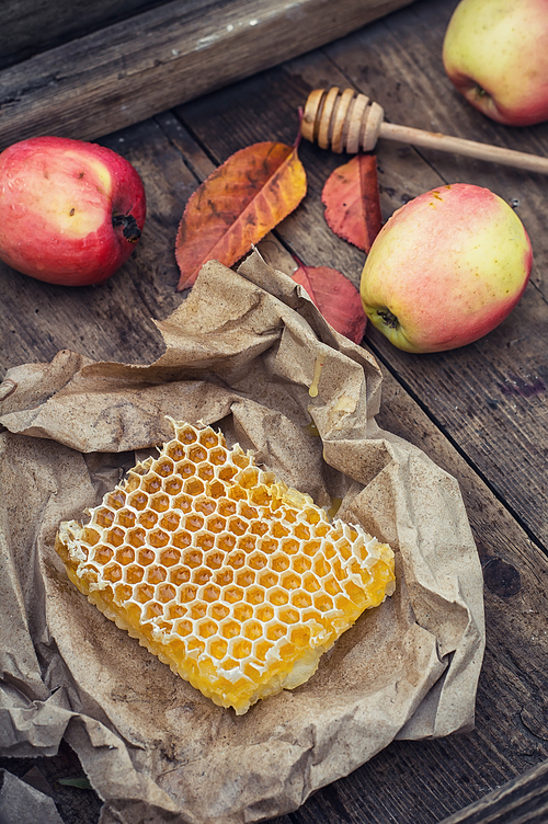 Still life with honeycombs apples and autumn leaves