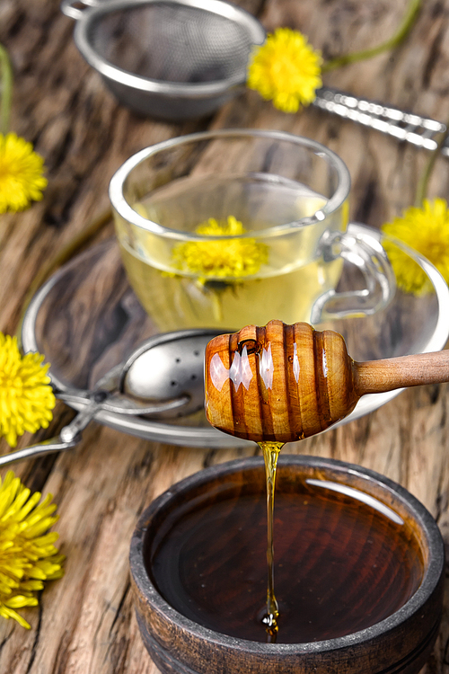 Cup of medicinal tea with healthy dandelion honey