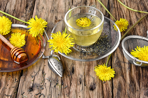 Cup of medicinal tea with healthy dandelion honey