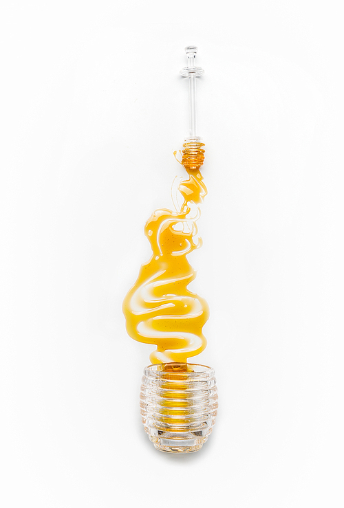 Honey poured from glass jar with spoon on white background, top view. Healthy  food