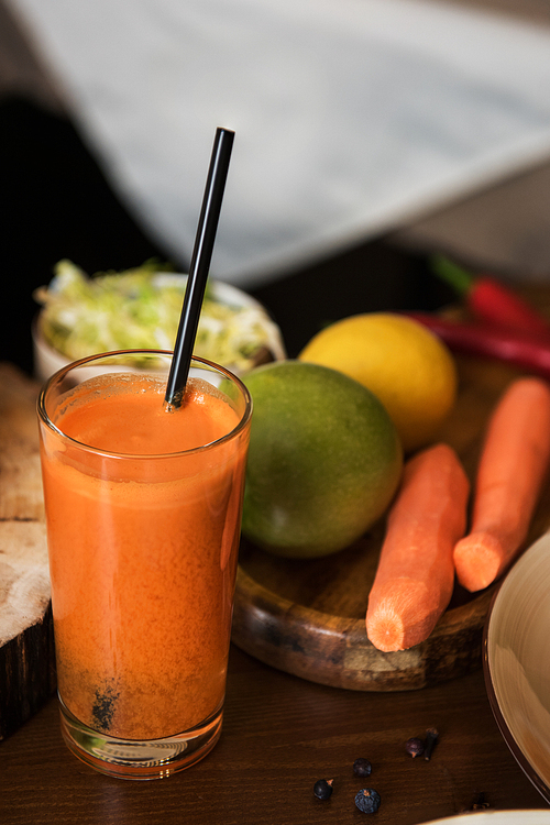 Healthy vegeterian food on brown wood board. Spring vitamin dieting food. Fruit and raw vagetables and carrot juice