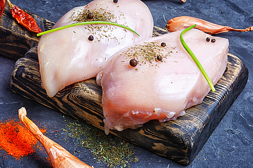 Raw chicken meat on the kitchen cutting board