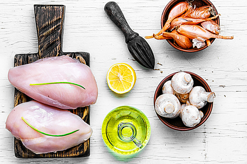 Raw chicken meat on the kitchen cutting board