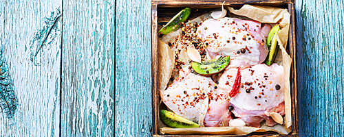 Raw chicken breast in spices on a wooden tray.Chicken meat