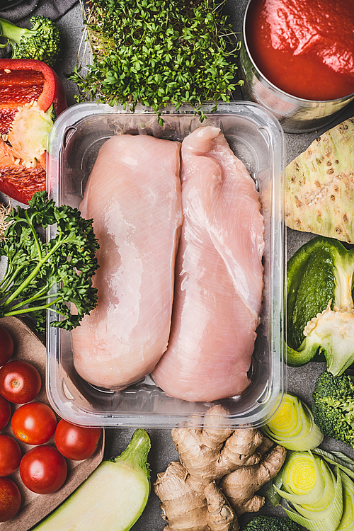 raw organic chicken breast fillets in plastic packaging tray with various s for tasty cooking, top view. healthy food and sports or diet nutrition concept