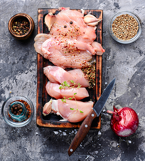 Raw chicken steaks on a kitchen board.Fresh and raw meat.