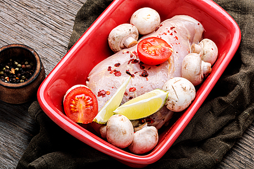 Fresh meat.Raw chicken meat with mushrooms in a baking dish.