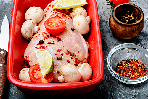 Raw chicken meat with mushrooms in a baking dish.Cooking ingredients