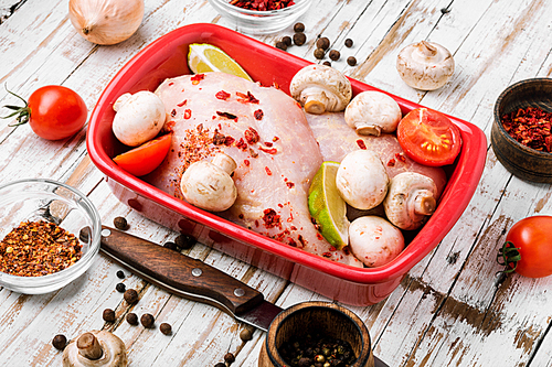 Raw chicken meat with mushrooms in a baking dish.Cooking ingredients.Chicken breast