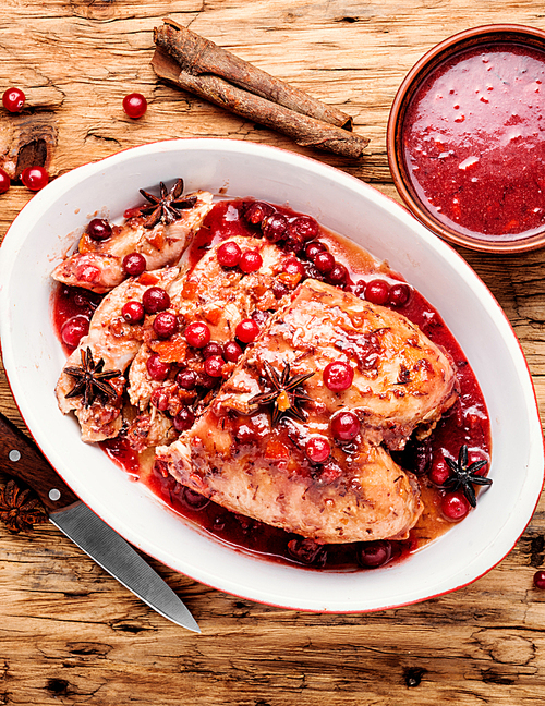 Grilled healthy chicken breasts with cranberry sauce.Sliced chicken breast